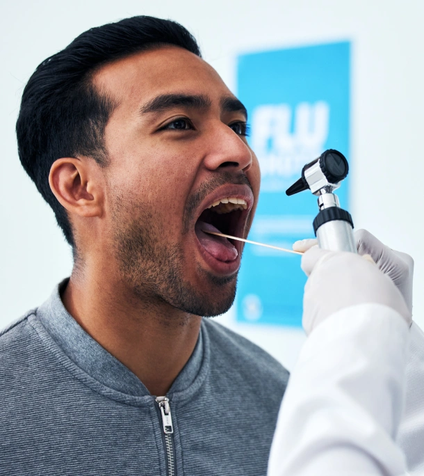 Man receiving dental examination with dentist in medical office setting